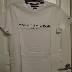 Vit T-shirt från Tommy Hilfiger med tryck över bröstet. Fint skick.
