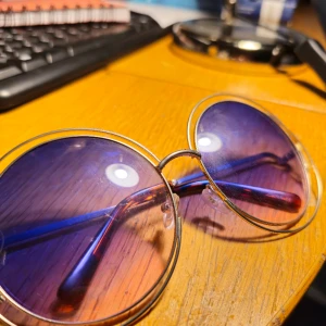 Eleganta 3949COL solglasögon, äkta märke i nyskick - Eleganta och färgglada lila solglasögon, inspirerade av Elton John, för män och kvinnor som vill utstråla glädje och självförtroende. Dessa solglasögon är designade med en glamorös touch, perfekta för att lägga till en trendig twist i din stil. Skapa ett 