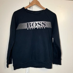 Huga boss tröja - Äkta hugo boss tröja i färgen mörkblåa. Säljs pga har en annan liknande i en annan färg. Den är inte alls mycket använd nästan i nyskick. 
