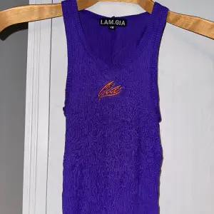 Bodycon semi-sheer vibrant purple tank top with contrast orange embroidered logo. Replicking. Too small on me. Gently used condition. Some fuzz but no pilling. No holes, tears, rips, stains, fading. Smoke and pet free storage space. 