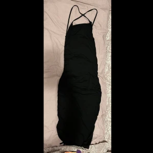 Svart klänning - Svart klänning med öppen rygg. Använd endast 1 gång, finns även bild på hur klänningen sitter på (skriv PM). Klänningen sitter tajt.
