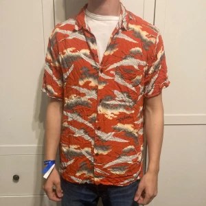 Hawaii skjorta från Vailent - Röd Hawaii skjorta från Vailent av Carlings, cool skjorta som funkar på sommaren eller till fest eller liknande.  Storlek L
