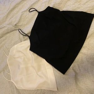 Två linnen 34 - Svart och vit bastopp/linne med spaghettistraps/tunna axelband. Topshop storlek 34.