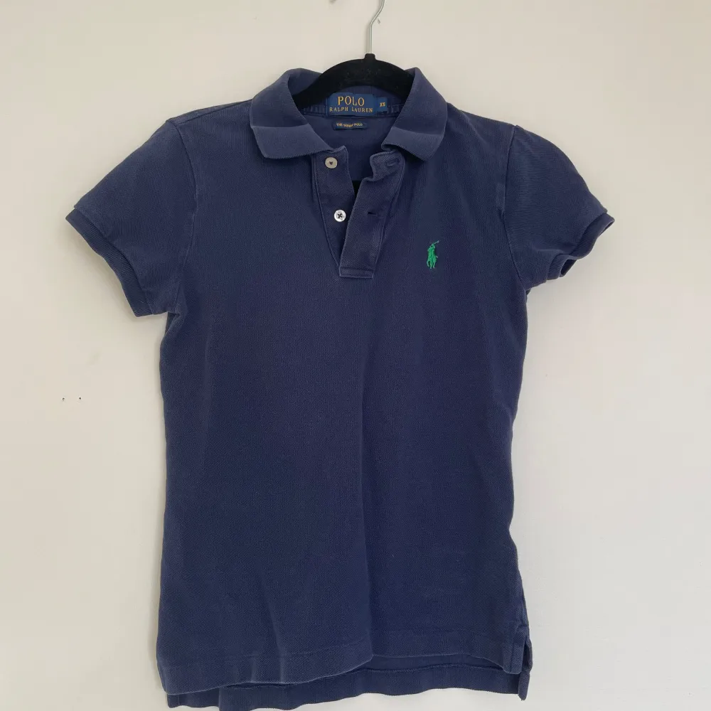 Marinblå Ralph Lauren polotröja i storlek XS i fint skick.. Toppar.