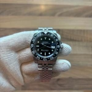 Seiko ”Bruce Wayne” GMT Mod 40mm - Tja! Har fått in en extremt cool Seiko ”Bruce Wayne” GMT Mod. Väldigt snygg och modern. Om klockan: NH34 automatisk  GMT rörelse. 904L stainless steel, C3 Lume. Sitter på den klassiska Jubilee länken. Helt ny såklart samt inplastad. Hör av er!