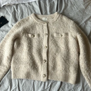 stickad kofta - Beige stickad kofta från H&M, har använt max 2 ggr, ganska varm för en kofta men väldigt mjuk och skön