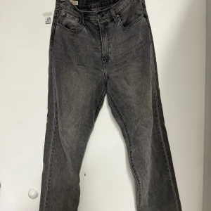 Levi's Stay Loose svarta jeans W31 L34 - Snygga svarta Levi's Stay Loose jeans i premiumkvalitet. Jeansen har en loose passform, raka ben och klassiska fem fickor. Tillverkade i slitstarkt denim med en cool tvättad look och läderpatch bak i midjan.