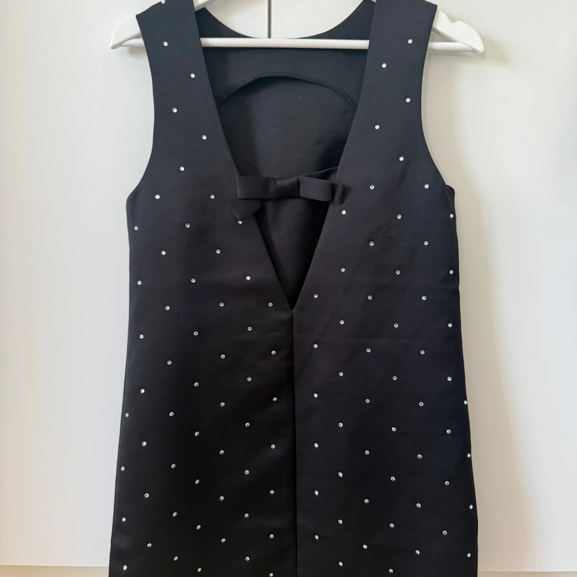 Svart kort klänning med paljetter på och en rosett i ryggen - 1