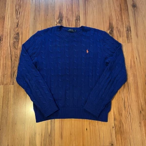 Blå stickad tröja från Polo Ralph Lauren - Blå stickad Ralph lauren tröja size M/175 🐎    Längd (66cm), bredd (51cm), ärm (65cm)           10/10 skick, aldrig använd, inga skador alls    Hör av er om ni har frågor 🤩