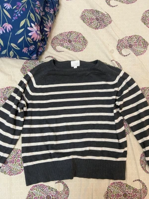 Stickad tröja - Grå stickad tröja med vita linjer.