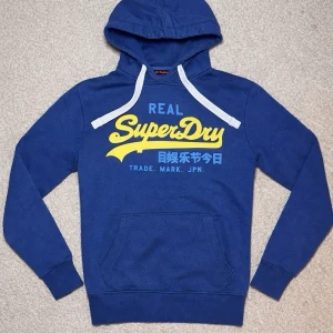 Superdry Hoodie - Tja! Säljer en Superdry Hoodie i storleken (M)-fast den sitter som en (S)-skick 8/10. Vid minsta lilla fundering hör av er!