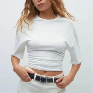 Vit croppad topp, från Gina Tricot - Säljer en helt oanvänd topp från Gina tricot i färgen vit. Storlek XXS.
