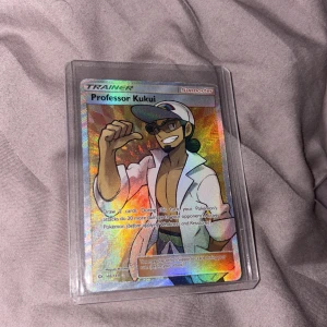 Professor Kukui - Cool och glittrig Pokémon-samlarbild med Professor Kukui! Perfekt för dig som vill boosta din samling eller spela Pokémon TCG. Kortet är i skyddsplast och har snygg holo-effekt – ett måste för alla Pokémon-fans!