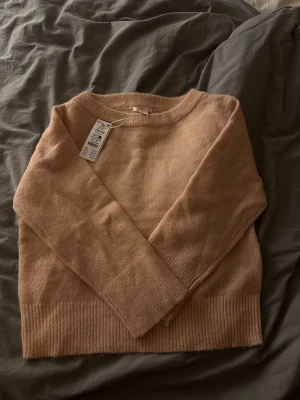 Ljusrosa stickad tröja från Gina tricot  - Supermysig helt ny ljusrosa stickad tröja från Gina med bred ribbad kant vid ärmslut och nederkant. Tröjan har en relaxed passform och rund halsringning, perfekt för chill dagar. Materialet är mjukt och skönt, och färgen är riktigt fräsch. 