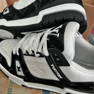 Louis Vuitton svartvita sneakers - Säljer ett par Louis Vuitton sneakers i svart och vitt med tydliga LV-loggor. Endast testade , köptes för ca 6-7mån sen. Inte min typ av skor stil längre. Storlek är 41 , passar även 42.                              Priset är förhandlingsbart:)