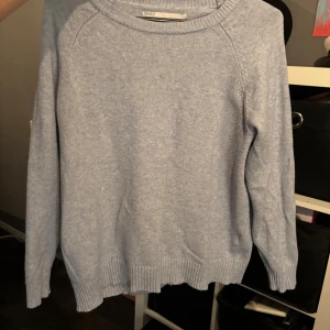 Ljusblå stickad tröja från ONLY - Mysig ljusblå stickad tröja från ONLY med rund hals och ribbade muddar vid ärmslut och nederkant. Perfekt för kyliga dagar och enkel att matcha med jeans eller kjol. Klassisk och stilren design som funkar till många olika looks.