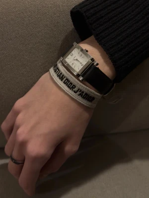 Christian Dior J’ADORE cotton bracelet  - Christian Dior J’ADORE bracelet in black and beige cotton. Adjustable and comfortable fit. Minimal signs of use. Perfect everyday accessory. 