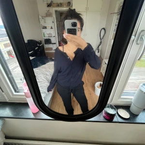 Mörkblå kofta från H&M Basic - Mysig mörkblå kofta från H&M Basic i storlek L. Koftan har knappar framtill och är långärmad med en enkel, klassisk design. Perfekt att slänga över en topp eller linne för en chill look.