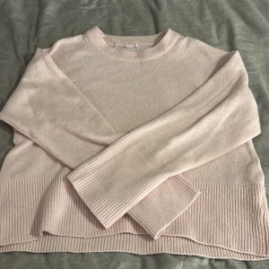 Ljusrosa stickad tröja från Gina Tricot - Supermysig ljusrosa stickad tröja från Gina Tricot. Tröjan har rund halsringning, långa ärmar och breda ribbade muddar vid ärmslut och nederkant. Perfekt för lager-på-lager och chill dagar.