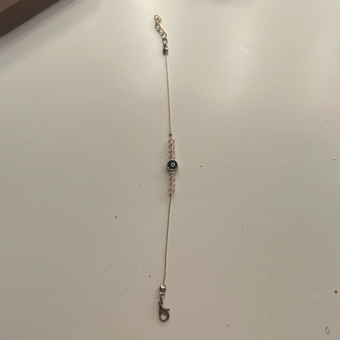 Guldigt armband med blått öga - 1