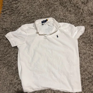 Vit pikétröja från Polo Ralph Lauren - Klassisk vit pikétröja från Polo Ralph Lauren. Tröjan är L men kan också passa XL