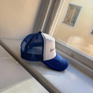  Born To Bogey keps - Snygg truckerkeps med blå och vit där det står 'Born To Bogey' för dig som vill sticka ut och göra din stil på golfen ännu bättre 