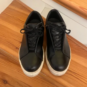 Svarta Eytys sneakers med vit sula - Säljer ett par svarta Eytys sneakers i skinn, fint skick defekt på bild 4! 