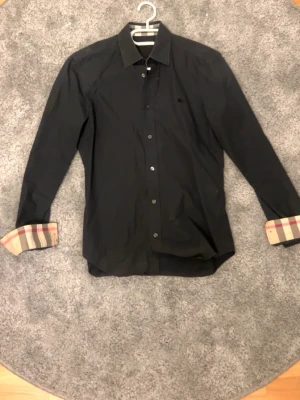Svart Burberry Brit skjorta - Skit grisch och fet Burberry skjorta med mönster på armar och krage. Pris kan diskuteras vid snabb affär!
