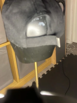 Svart keps från Polo Ralph Lauren - Snygg svart keps från Polo Ralph Lauren med klassisk broderad logga i vitt framtill. Kepsen har böjd skärm med vit kant och justerbar rem baktill. Perfekt accessoar för en sportig och chill stil.