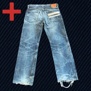 Vintage Momotaro GTB Selvedge Straight  - Ett par riktigt snygga Japanska Selvedge Momotaro GTB Straight! Storlek på taggen: 34 (se mått nedan). Fint skick, har slitningar från användning som ger fin patina, fläckar vid grenen och över plagget på framsidan. Skriv om du har frågor!  Mått: Storlek på tag – 34, Midja – 42.5 cm, Lår – 31 cm, Innersöm – 81 cm, Längd – 102.5 cm, Benöppning – 23 cm