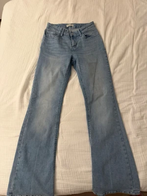 Ljusblå bootcut jeans  - Säljer ett par ljusblå bootcut jeans från Lindex i storlek 164. Materialet är mjukt denim och passformen är normal.