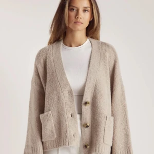 Beige stickad kofta med stora knappar - Aldrig använd från lounge underwear. Nypris 820kr. Mysig beige stickad kofta med v-ringning och stora bruna knappar framtill. Koftan har två rejäla fickor och breda ribbade muddar vid ärmslut och nederkant. Passformen är loose och ärmarna är långa, perfekt för lager-på-lager. 