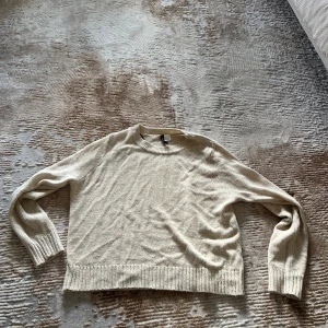 Beige stickad tröja från H&M - Mysig beige stickad tröja från H&M. Perfekt för lager-på-lager och enkel att matcha till jeans eller kjol. 