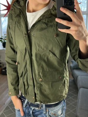 Parkas jacka olivgrön  - Perfekt nu i vinter! Finns ett hål i en armhåla men inget som påverkar den totala looken,  skriv vid fundering. Mått: A:44 B:45 C:39 D:60 (cm) 😊🙏