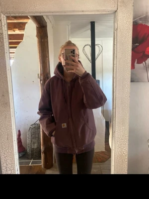 Vinröd hoodiejacka från Carhartt - Hjälper mamma att sälja sin Carhartt jacka, inte mkt använd, i finfint skick! I färgen plommon! Kan inte hitta att den går att få tag i längre.   Finns också på Vinted med jackan!  Nypris minst 2500kr för en liknande!