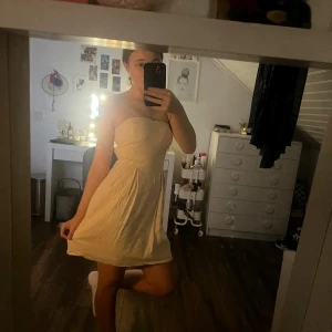 Champagnefärgad kort klänning från Vila - Säljer en söt champagnefärgad klänning från Vila i storlek S. Klänningen är kort utan axelband och har en figurnära överdel som går ut i en lätt utställd kjol. Materialet är mjukt och har en lätt glans. Aldrig använd säljer för att den är för stor och aldrig kommer till användning 🫶