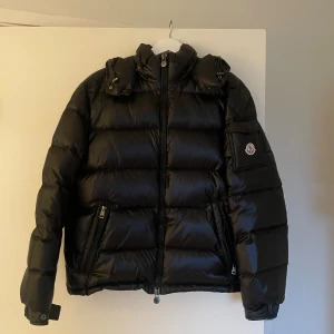 Moncler Maya Jacka - Hejsan jag säljer min killes moncler Maya som han köpte i Polen. Säljer den pga att den är för liten för honom. Jackan har tagits hand om väldigt väl och är i nytt skick. Moncler påse tillkommer samt kvitto vid köp av jackan.   Skriv gärna om ni har frågor och funderingar!  Äktighetscertifikat/kvitto finns, skriv bara i dm så skickar jag det💕