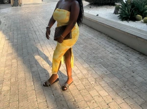 Gul axelbandslös långklänning - Snygg axelbandslös långklänning i gult och vitt med slits på sidan. Klänningen har en figurnära passform och är perfekt för varma dagar. Mönstret är lätt marmorerat och materialet känns mjukt och följsamt.