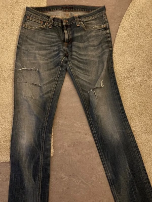 Blå slitna jeans från Nudie Jeans - Skitfeta nudie jeans men grymt fräsch tvätt. Ganska smal i modellen. W32 l34. Skriv vid eventuella frågor och funderingar! 