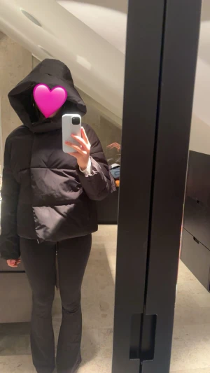 Vinter jacka  - Svart pufferjacka från Vero Moda med stor huva och dragkedja framtill. Jackan är quiltad och har långa ärmar, perfekt för kalla dagar. Materialet är polyester och modellen är loose fit för en chill vibe.