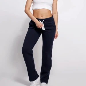 Mjukisbyxor  - Säljer mina jättefina lågmidjade russemerch mjukisbyxor i marinblå då de tyvärr var för korta🥲 kan gärna tänka mig byta också mot tall modellen. Dom ser som nya ut🩷🩷