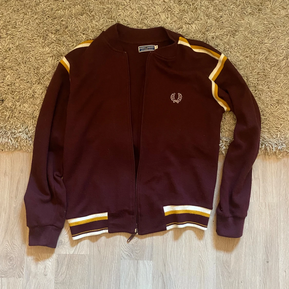 Vinröd Fred Perry kofta med gula ränder