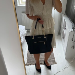 Äkta Michael kors väska - Så snygg äkta väska från Michael kors. Får plats med dator och mycket annat i. Väl använd men fortfarande väldigt bra skick. Finns dock små skavanker som man kan se på sista bilden, skriv privat för fler bilder! Finns kvitto och äkthetsbevis