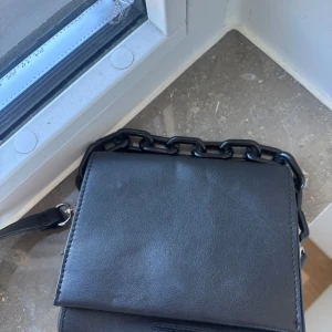 Svart axelväska med kedjedetalj från Carin Wester - Knappt använt! 