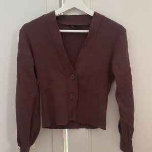 Brun kofta från Gina Tricot - Brun stickad kofta med knappar från Gina trugor i storlek S. Använd typ 2 gånger och är i ett väldigt bra skick
