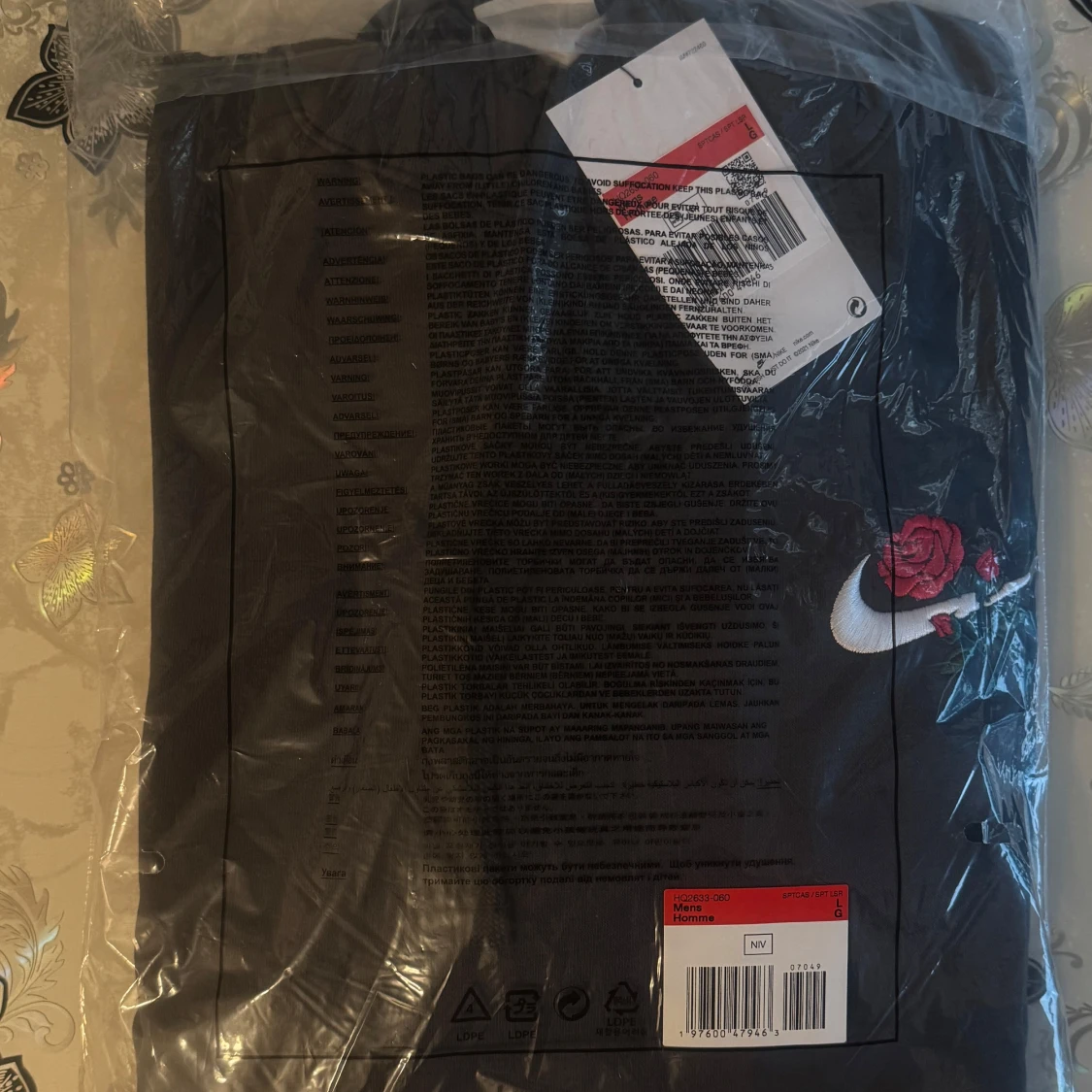 Mörkgrå hoodie med rosbroderi från Nike