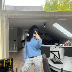 Ljusblå stickad tröja - Säljer en ljusblå stickad tröja med rund hals och långa ärmar. Tröjan har en mjuk och mysig känsla, perfekt för kyligare dagar. Enkel och stilren design som passar till mycket.