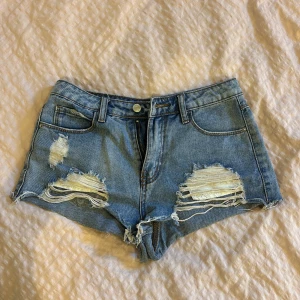 Blå ripped jeansshorts  - Supersnygga lågmidjade shorts! Köpte dem second hand💗