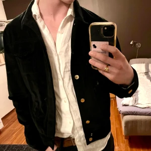 Yves Saint Laurent jacka/overshirt - Säljer en svart mocka jacka/overshirt från Yves Saint Laurent med guldknappar. Köpt på Baubau, en secondhand butik som specialiserar sig i designer. Köptes för 4000 kr kvitto finns