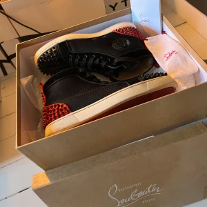 Christian Louboutin skor - PRIS KAN DISKUTERAS! Säljer mina SUPERsnygga, coola, unika sneakers från Christian Louboutin med röda och svarta nitar!❣️Säljer dem så de tyvärr är för stora för mig som vanligtvis är storlek 39-40😢du får med box och allt som tillhör! Dessa säljs inte längre och nypriset på de ligger troligen runt 12-15k❣️Perfekt nu till våren/sommaren! 